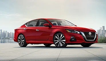 2023 Nissan Altima in red with city in background illustrating last year's 2022 model in Nissan of Fremont in Fremont CA