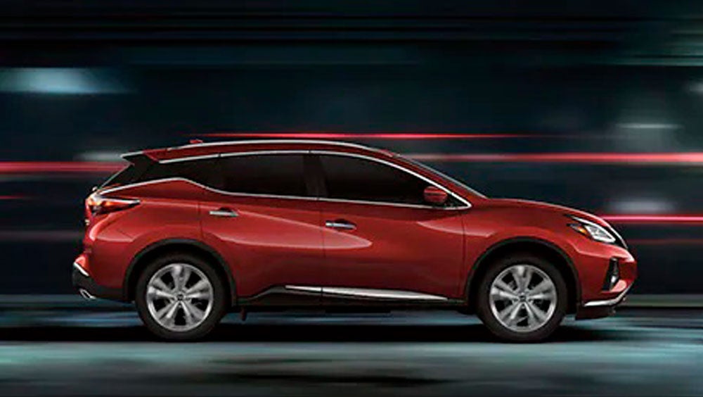 2023 Nissan Murano shown in profile driving down a street at night illustrating performance. | Nissan of Fremont in Fremont CA